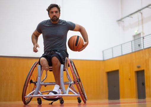 Man playing basketball in a wheelchair